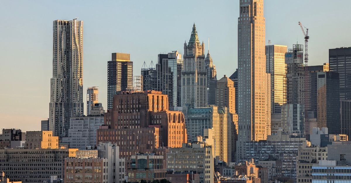 Iconic New York City skyline bathed in warm sunset light, highlighting urban architecture.