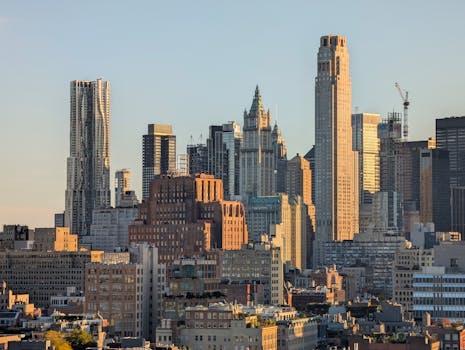 Iconic New York City skyline bathed in warm sunset light, highlighting urban architecture.