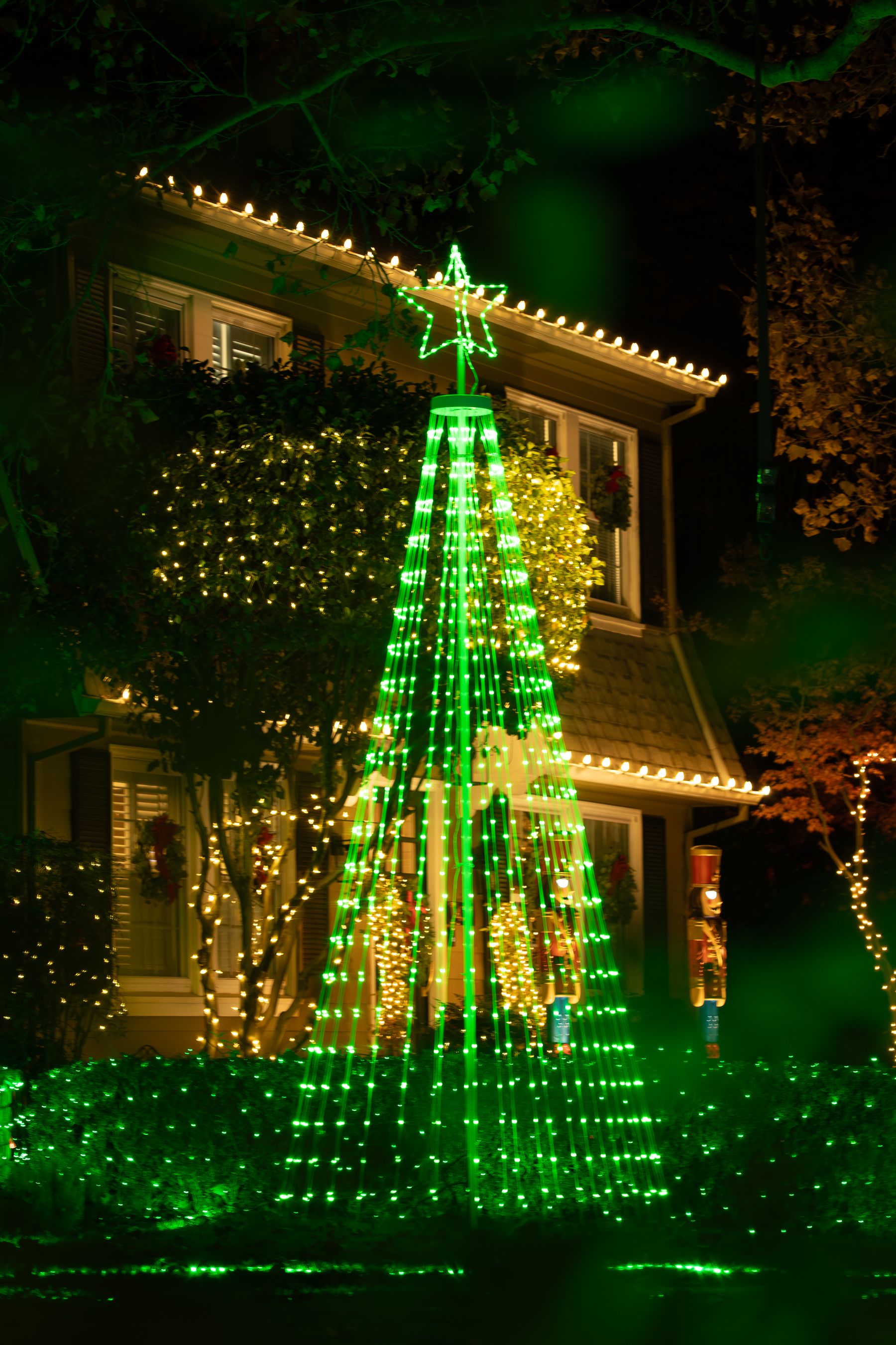 House outlined with holiday lights at night