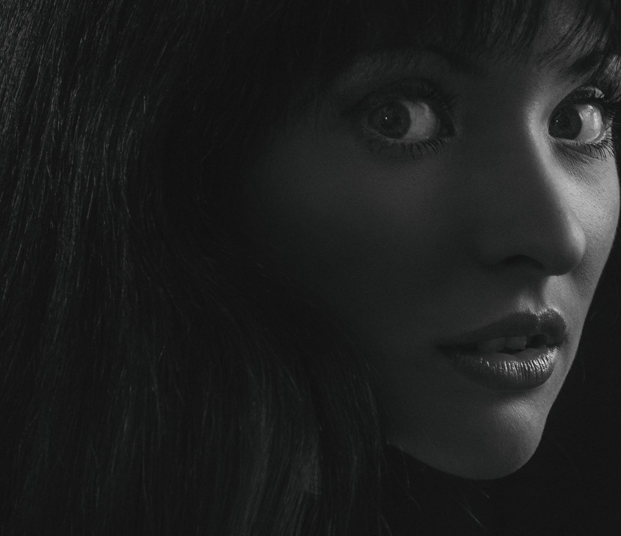 close up black and white portrait of a woman with expressive eyes and