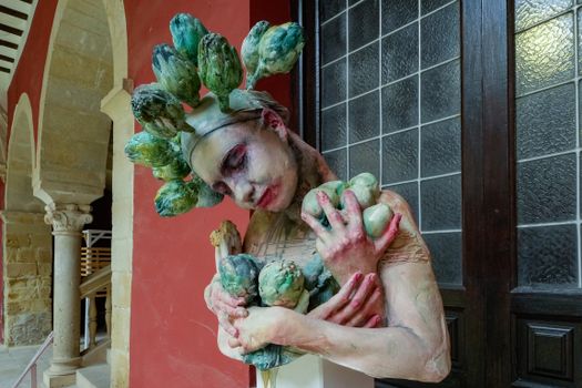 A captivating surreal art performance with leafy costume in a historic setting in Úbeda, Spain.