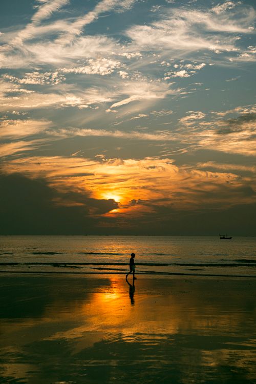 Free A captivating sunset over an Indian beach, featuring a tranquil silhouette and vibrant sky. Stock Photo