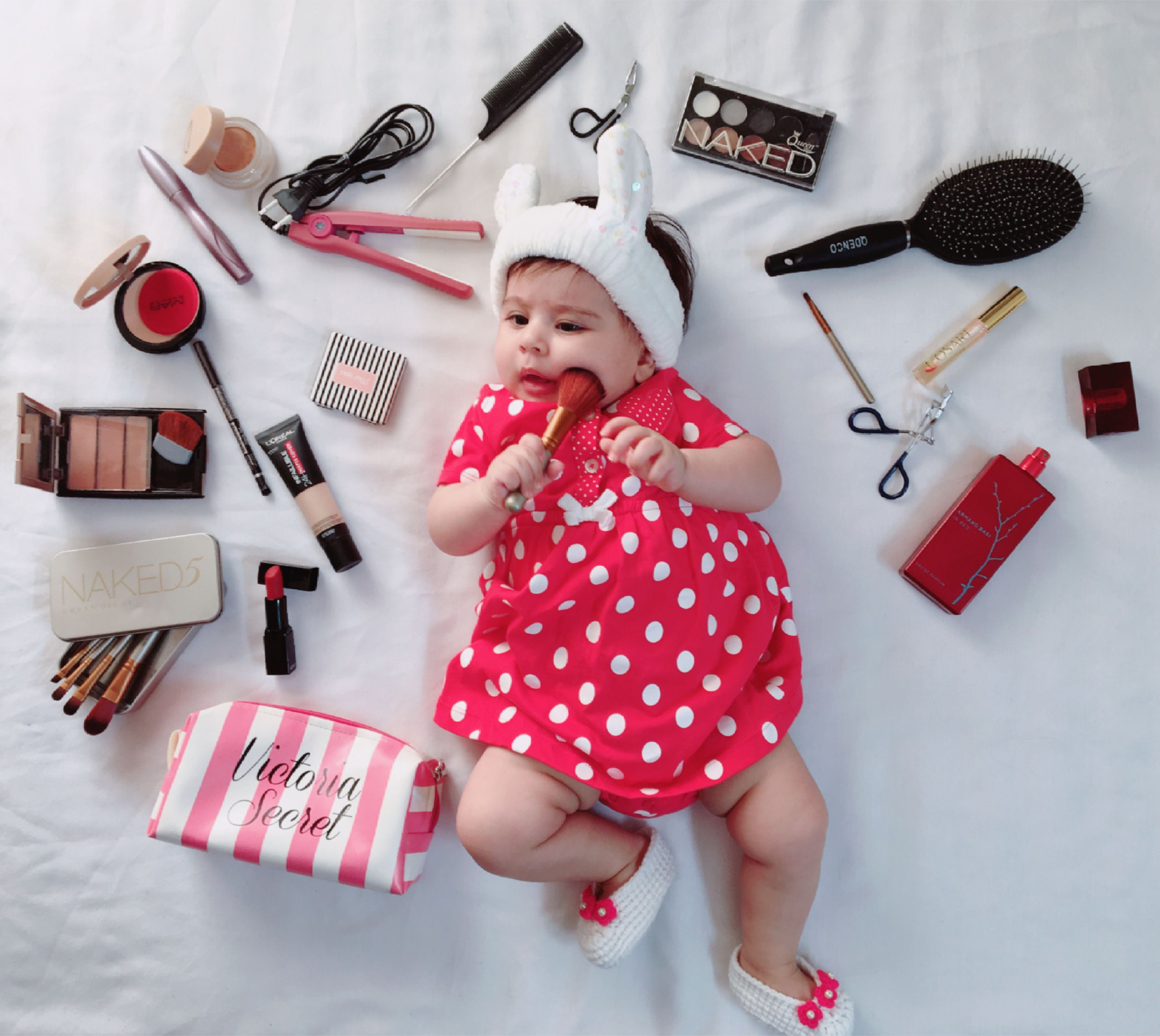 adorable-baby-surrounded-by-makeup-and-cosmetics-free-stock-photo