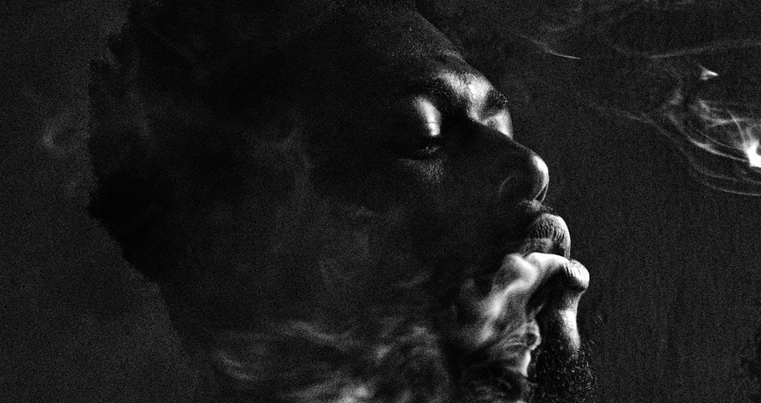 Monochrome Photo Of Man Releasing Smoke in Recife, Brazil.