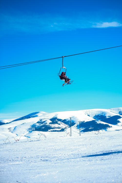 Ski Lift Against Blue Sky in Snowy Mountains · Free Stock Photo