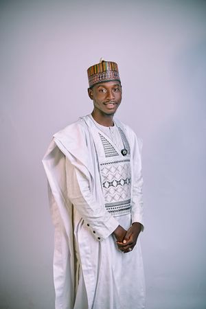 Groom in refined native wear, smiling