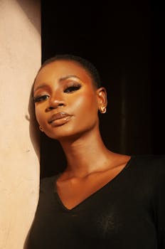 Striking portrait of a confident young woman with warm lighting accentuating her features.