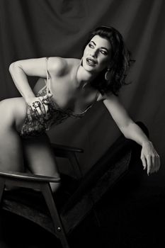 Vintage-inspired black and white portrait of an elegant woman posing with grace.