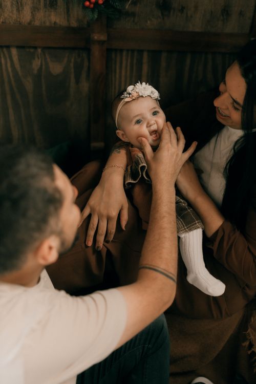 Free Happy family bonding with a laughing baby indoors, capturing love and joy. Stock Photo