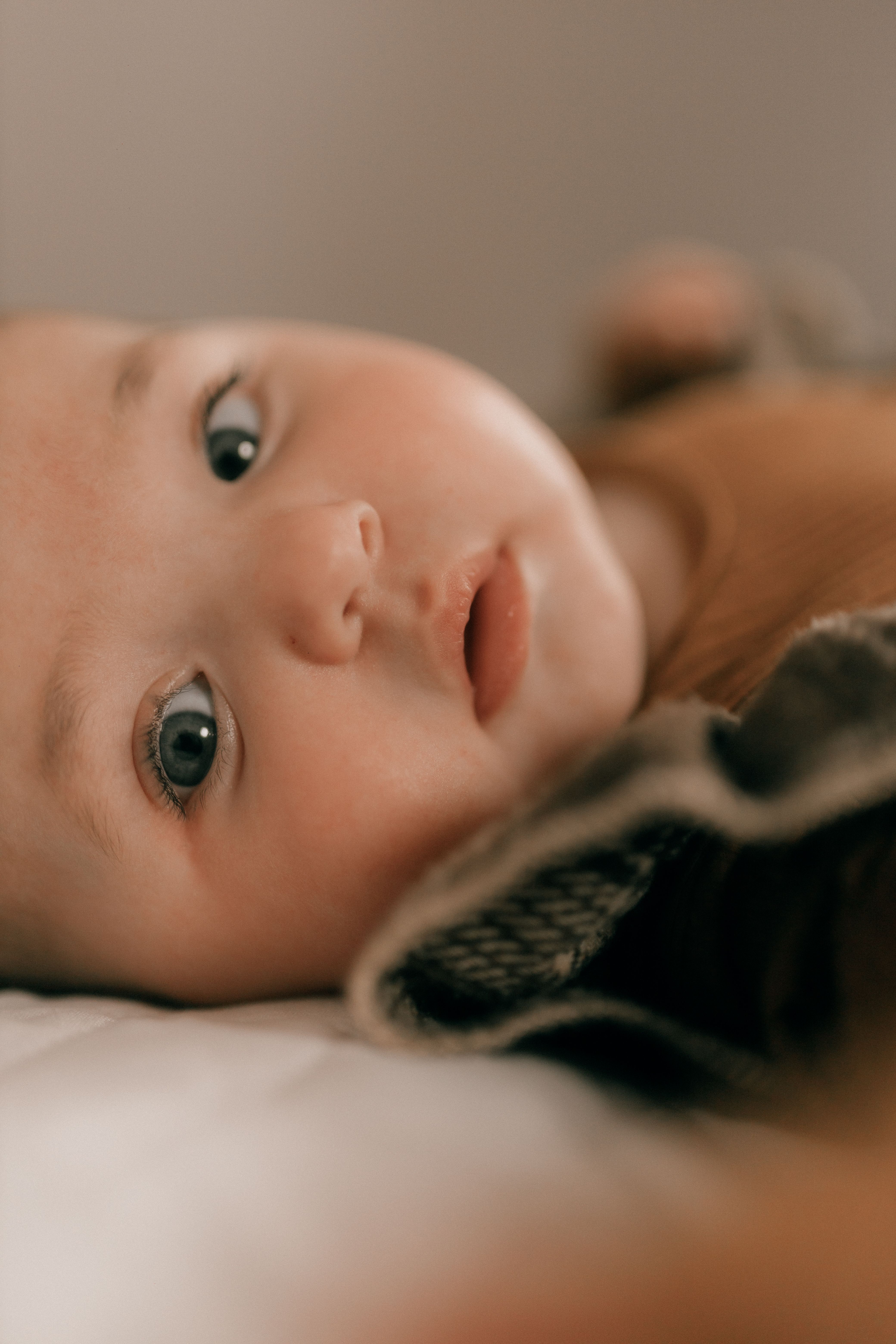 Close-Up Portrait of a Curious Baby Indoors · Free Stock Photo