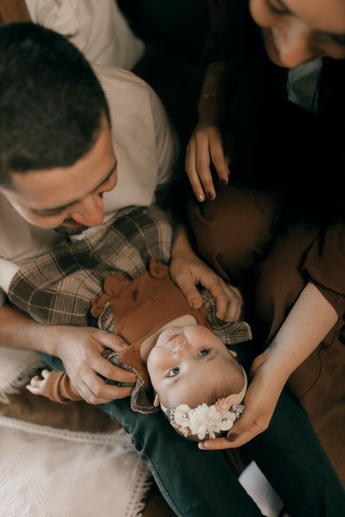 Free A warm and intimate moment of parents bonding with their baby indoors. Stock Photo