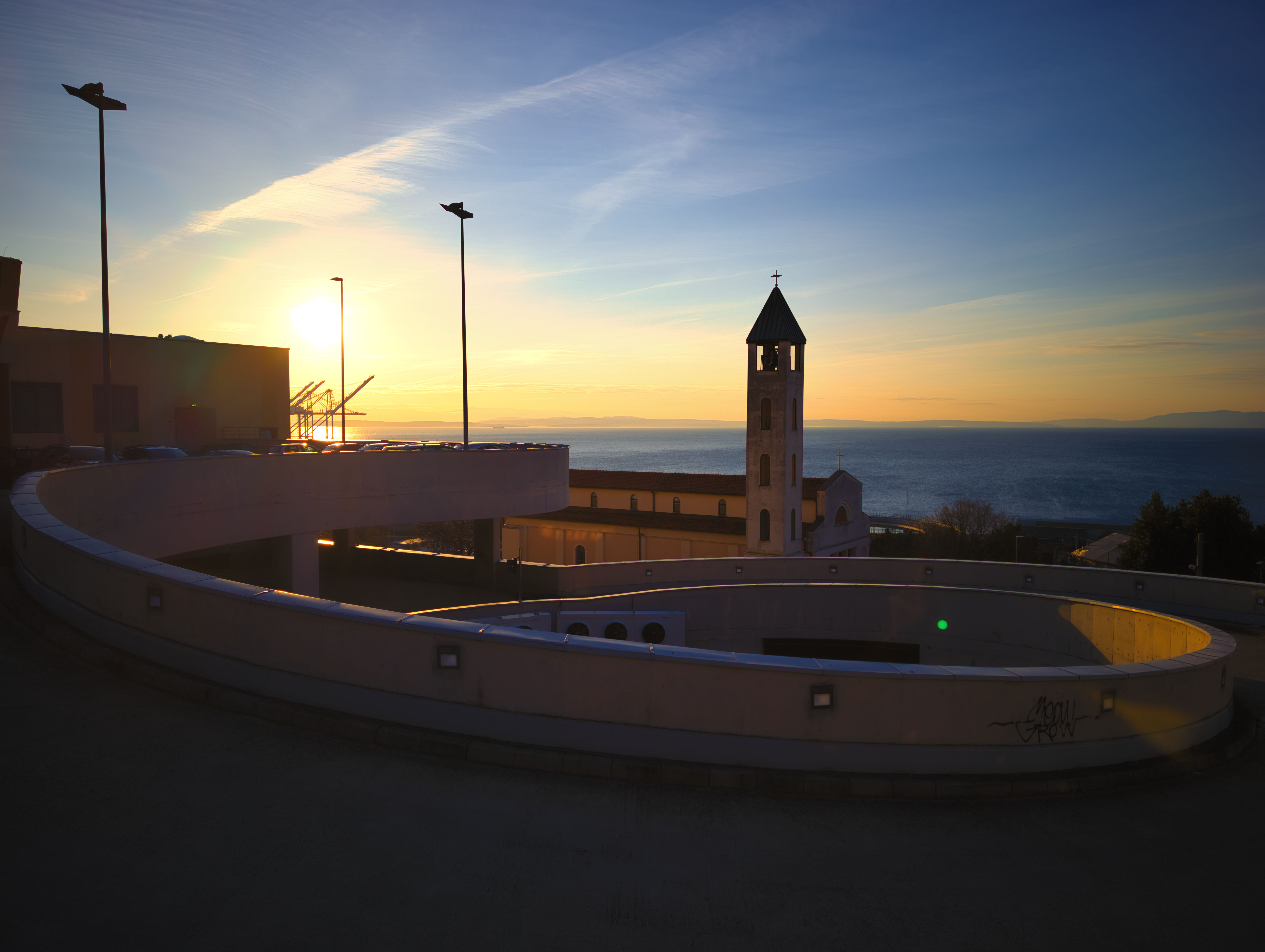 Beautiful sunset over Fiume in Croatia with a striking church tower and sea backdrop.