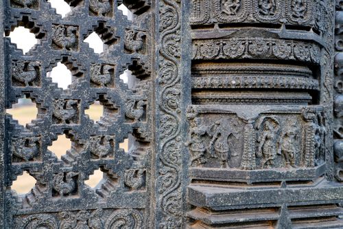 Free Close-up of detailed stone carvings on an ancient temple wall showcasing historical craftsmanship. Stock Photo