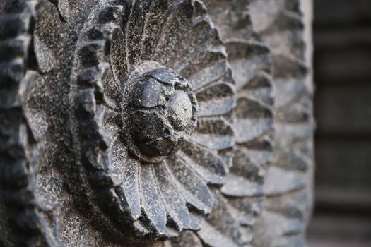 Close-up of intricate stone carving, showcasing detailed craftsmanship and texture.