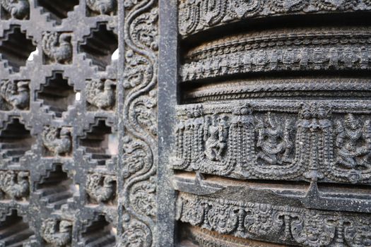 Close-up of ornate stone carvings on an ancient temple wall showcasing detailed craftsmanship.
