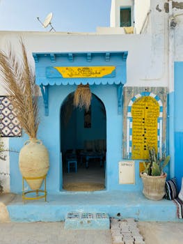 Captivating blue and yellow entryway with unique decorations and traditional Tunisian charm.