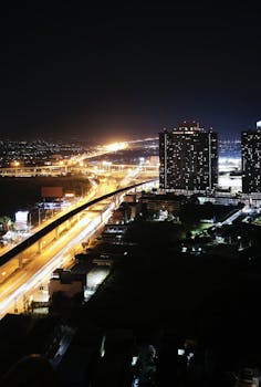 A stunning night view of illuminated highways and skyscrapers in Bangkok, Thailand.