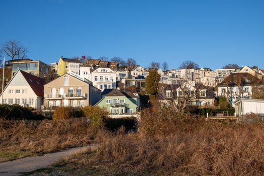 Scenic view of charming hillside houses in Blankenese, Hamburg with a clear blue sky.