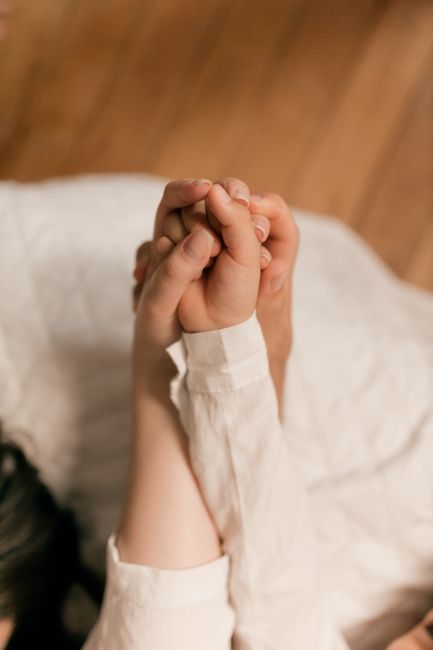 Intimate close-up of two joined hands symbolizing love and unity.