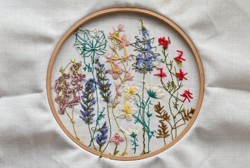 Free Vibrant needlework of wildflowers on fabric in a wooden hoop. Stock Photo