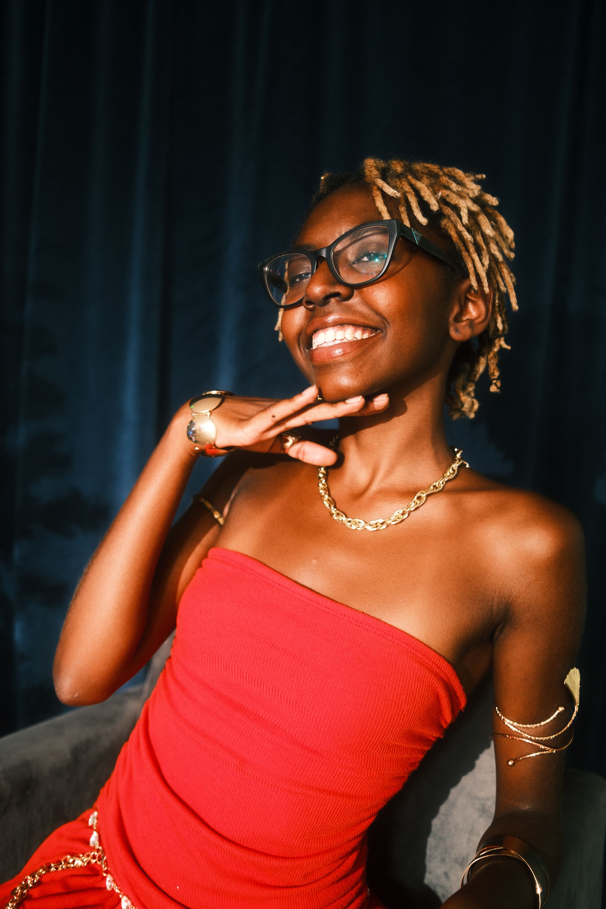 Stylish Woman Smiling in Red Dress with Accessory · Free Stock Photo
