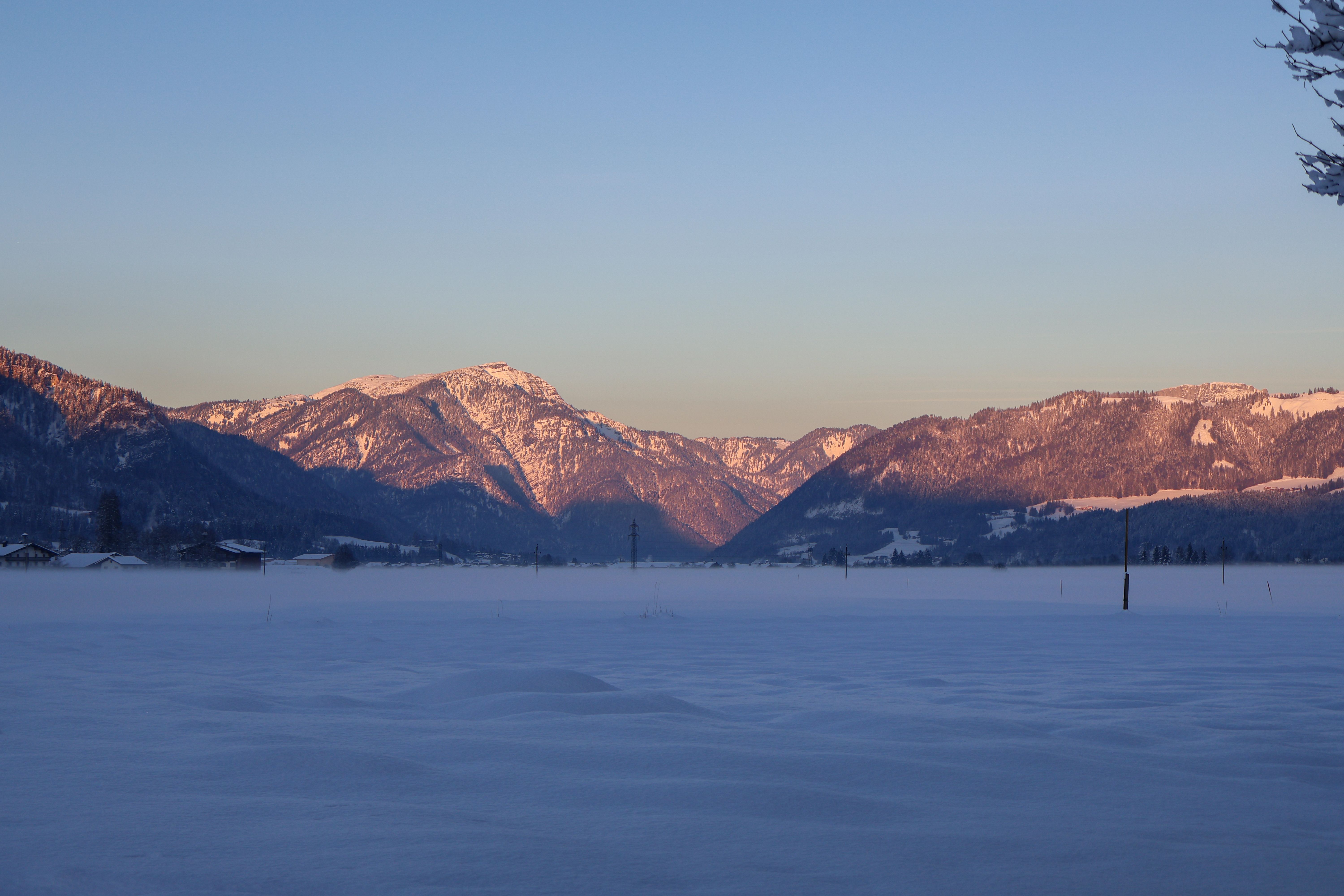 Scenic view of snowy mountains at sunrise in Oberndorf, Tirol, Austria.