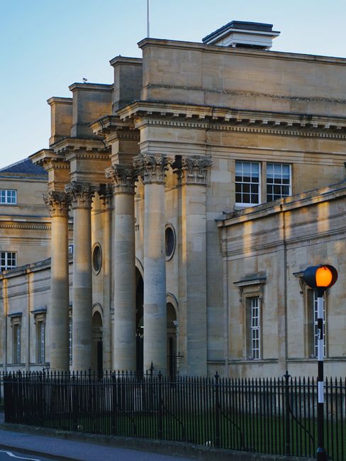 Elegant facade of a classical building at Oxford University during sunset.