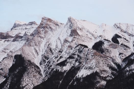 Breathtaking view of snow-covered Rocky Mountains in Banff National Park during winter.