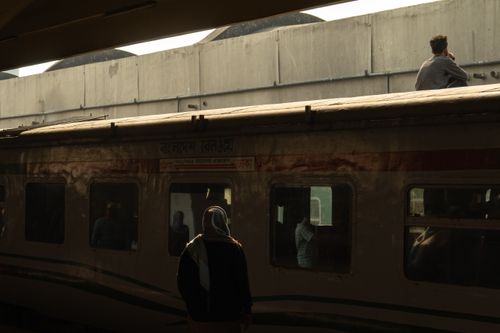 Free A silhouette of people inside and outside a train at a station in Bangladesh during daytime. Stock Photo