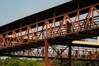 Rustic Pedestrian Bridge with People Silhouettes