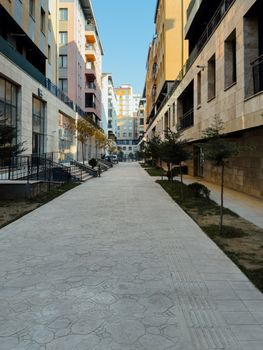 A view of contemporary apartment buildings lining a clean, empty street in Elazığ, Türkiye.