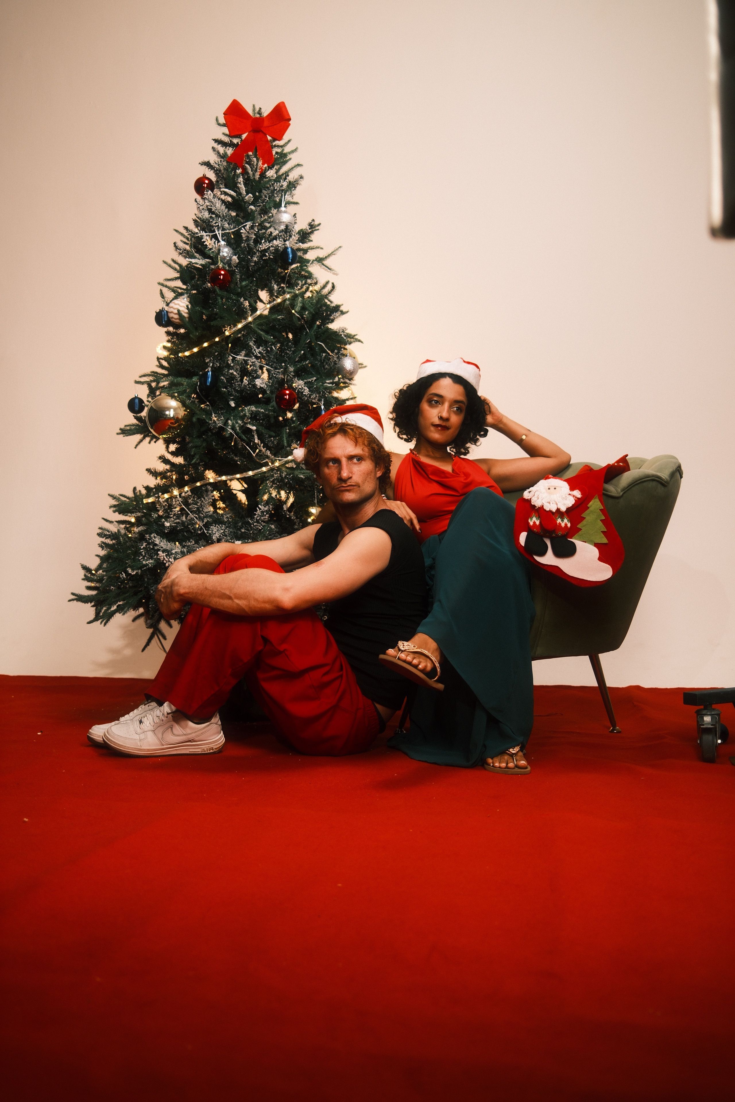 Festive Couple Posing by Christmas Tree Indoors · Free Stock Photo