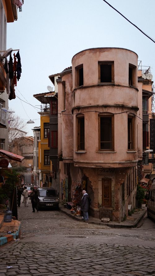 Free Explore a quaint street with historic buildings and cobblestone path, perfect for travel and culture enthusiasts. Stock Photo