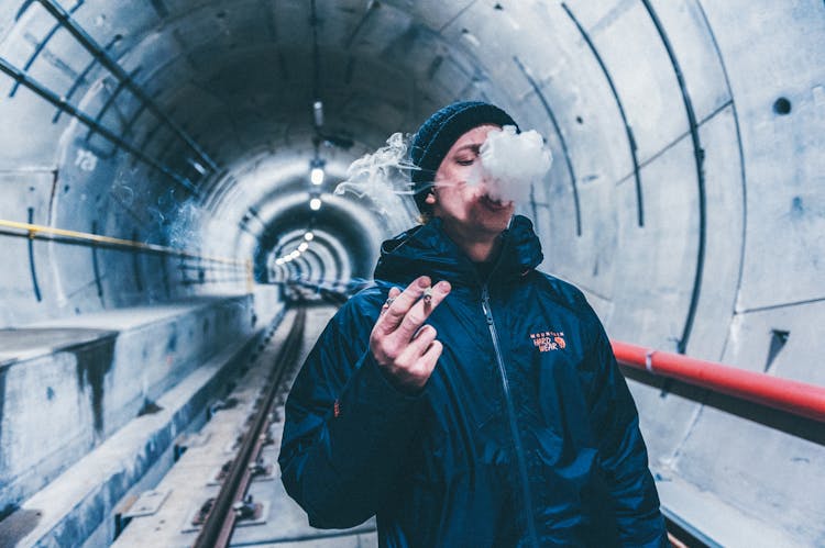 Shallow Focus Photo Of Man Smoking Cigarette