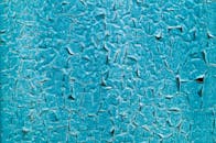Close-up of Cracked Turquoise Paint Texture