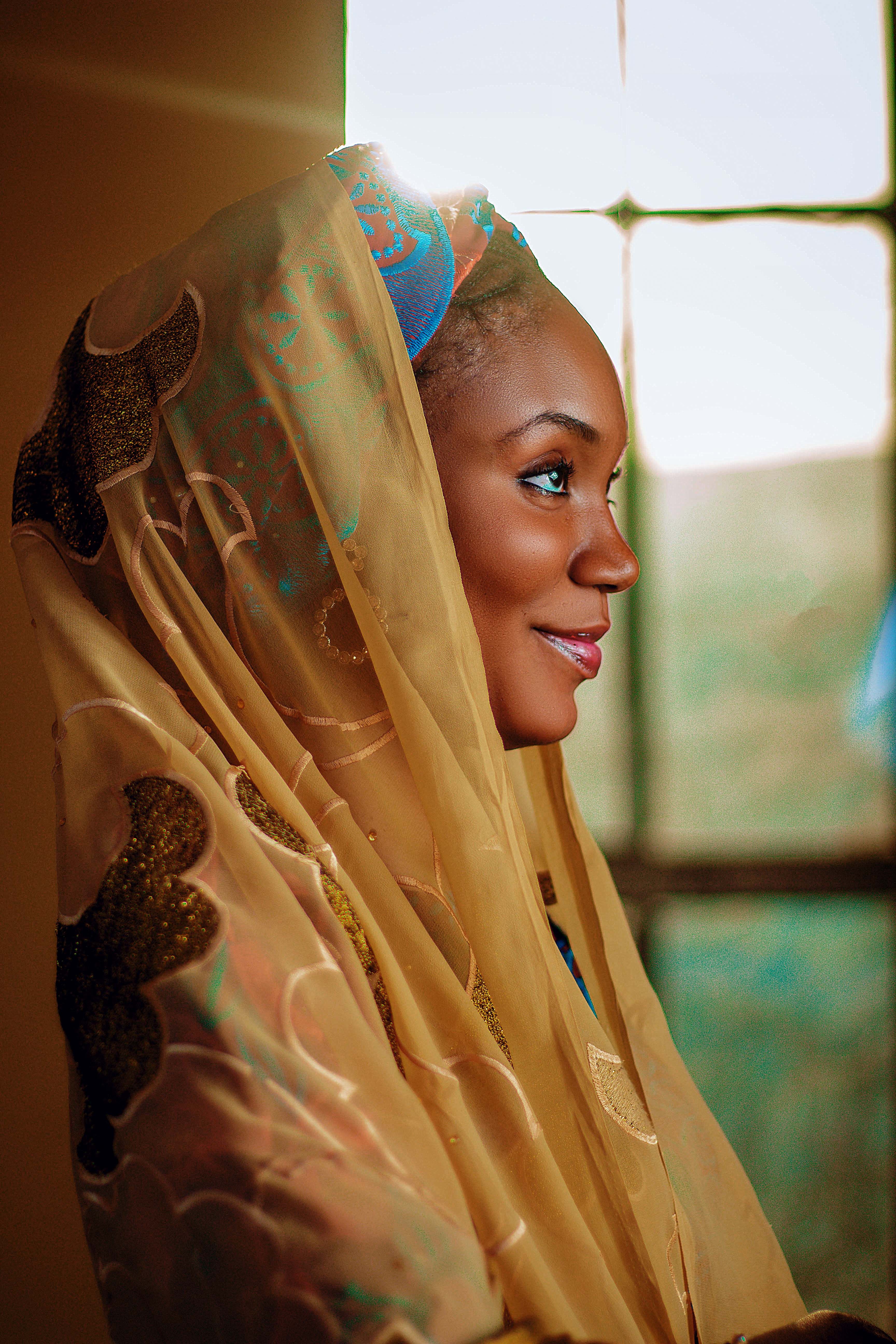 Portrait of a Woman in Ornate Headscarf · Free Stock Photo