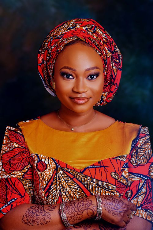 Free Portrait of a woman in vibrant African dress with henna tattoos. Stock Photo
