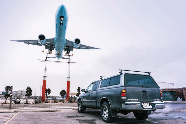 Airplane In Flight Over Pickup Truck