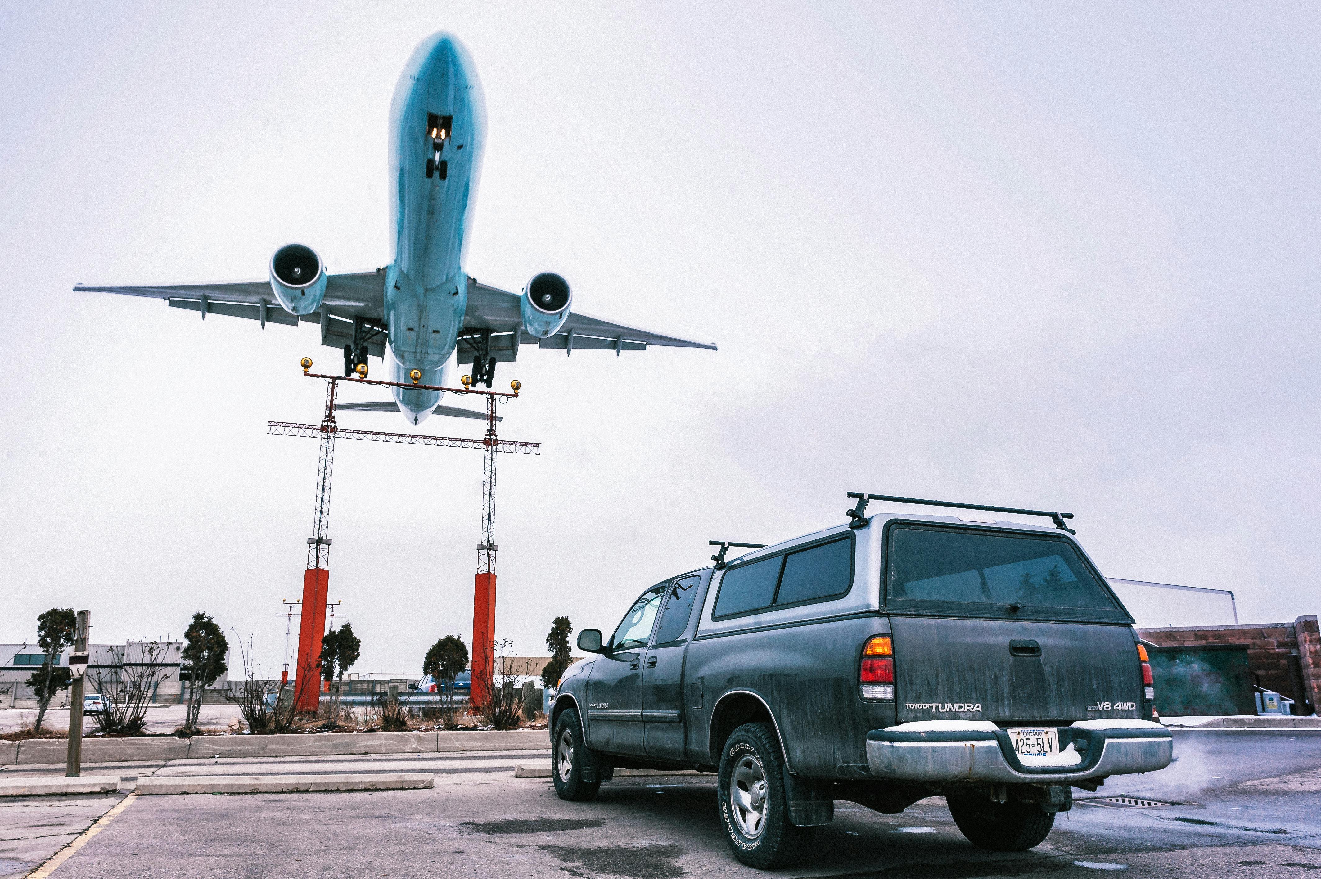 Airplane in Flight over Pickup Truck · Free Stock Photo