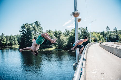 Free Man Flipping over Water Stock Photo
