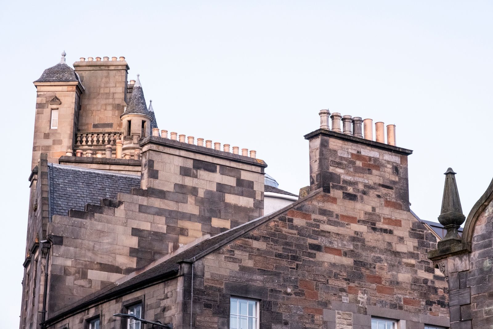 Edinburgh stone rooftops and chimneys at sunset