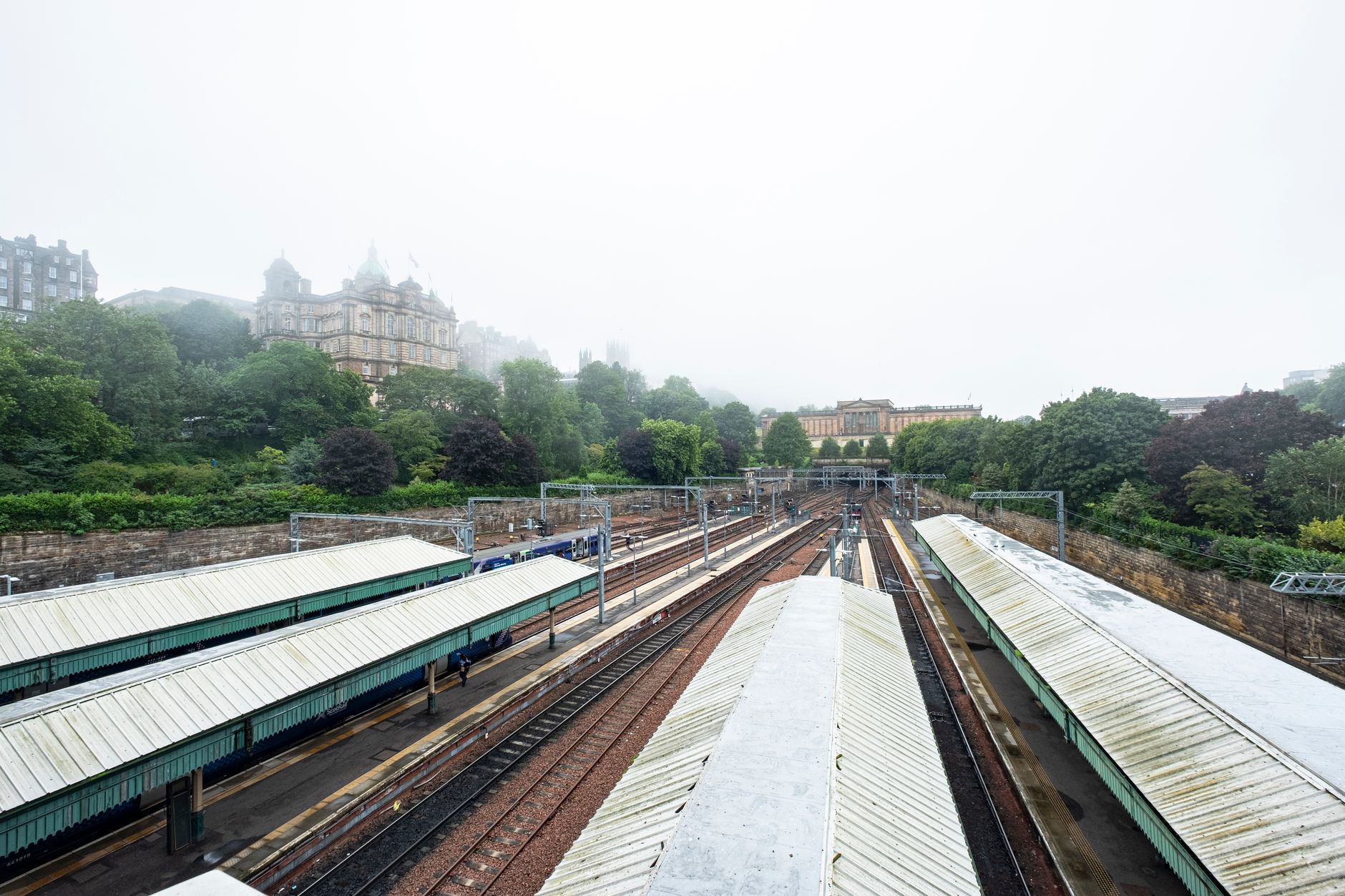 Misty morning view of train tracks in Edinburgh, a classic start to a scotland train itinerary.