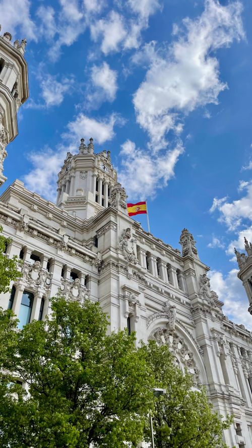 Free Stunning view of Palacio de Cibeles with Spanish flag in Madrid. Stock Photo
