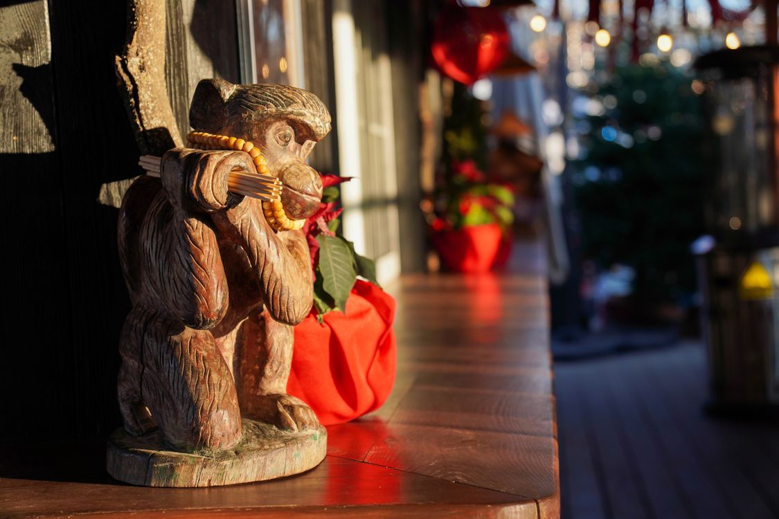 Rustic Monkeys Rustic Monkey Statue with Holiday Decor in Kyiv · Free Stock Photo