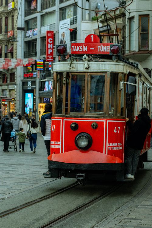 Free Iconic red tram captures the essence of İstanbul's bustling İstiklal Avenue with vibrant urban life. Stock Photo