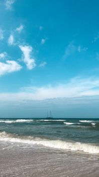 Peaceful beach with gentle waves and clear blue sky in Rincón, Morocco.