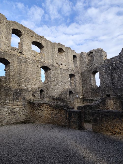 Free Ancient stone ruins featuring arched windows and a blue sky, showcasing historical architecture. Stock Photo