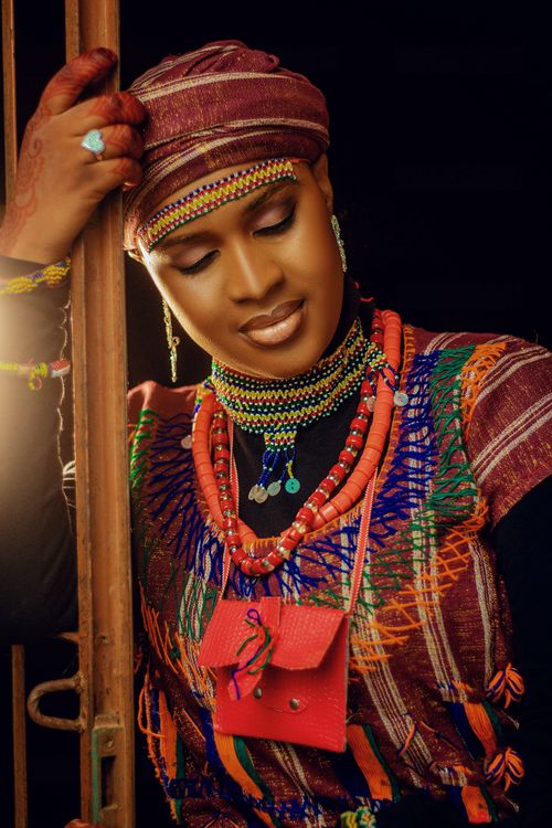 Free Portrait of a woman in colorful, traditional African attire with intricate beading. Stock Photo