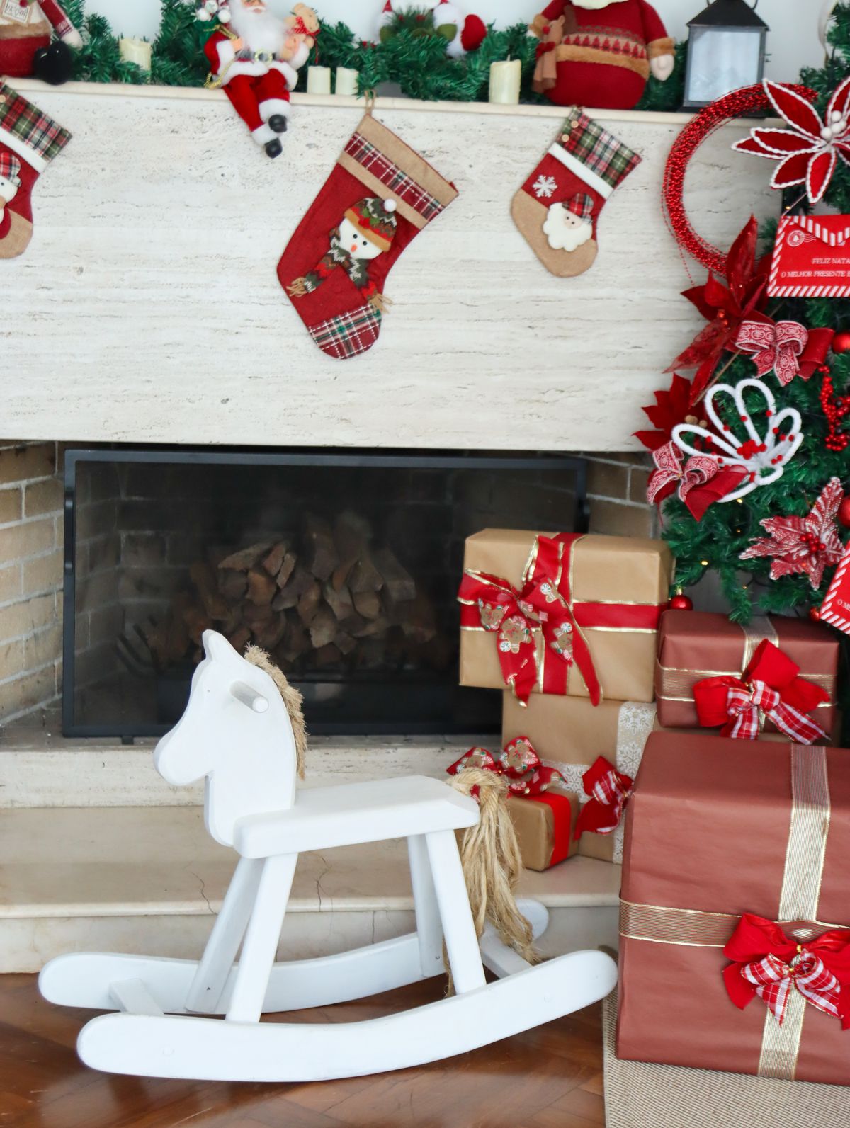 Classic Christmas fireplace with stockings, wreath, garland, and gifts