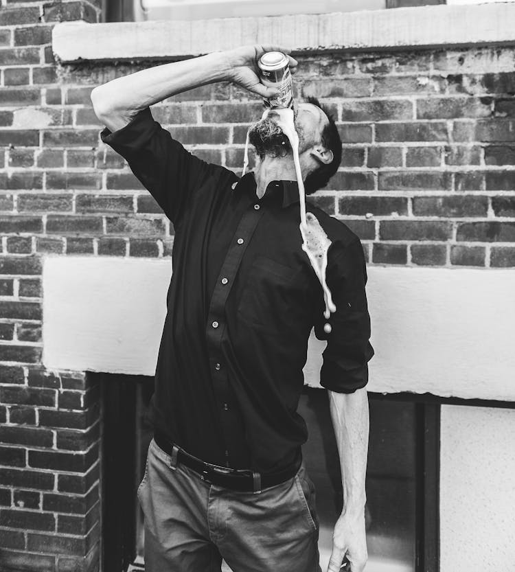 Man In Black Dress Shirt Drinking Canned Drink